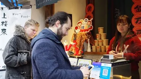 Foreign tourist paying by QR code at a Chinese street food stall