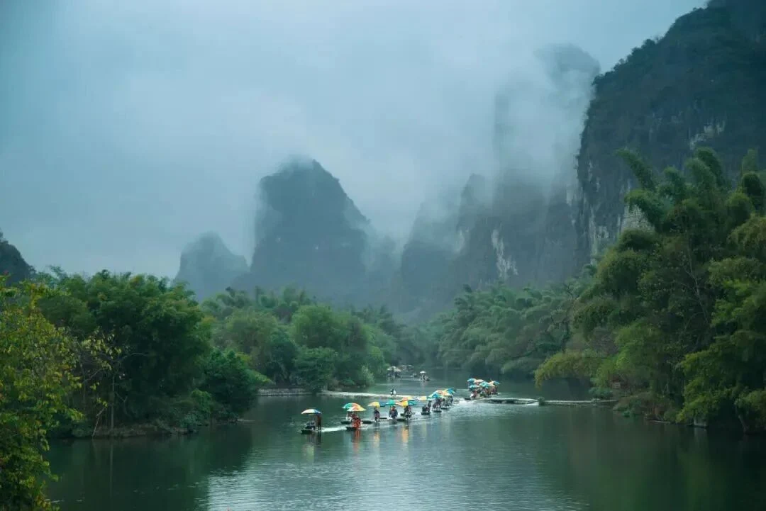 Morning mist over Yulong River karst peaks near Yangshuo riverside hotels
