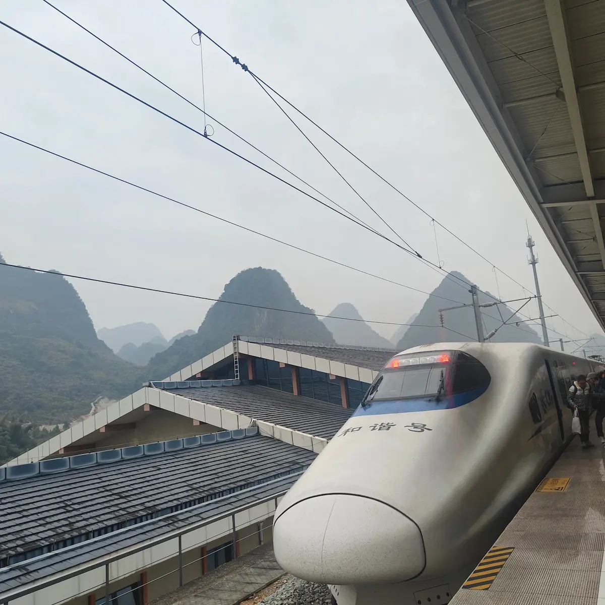 High-speed train at Guilin Railway Station with karst peaks
