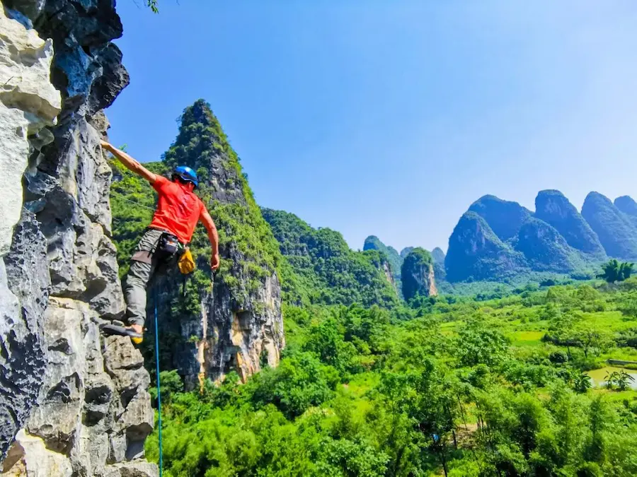 Rock climbing on a karst limestone wall in Yangshuo