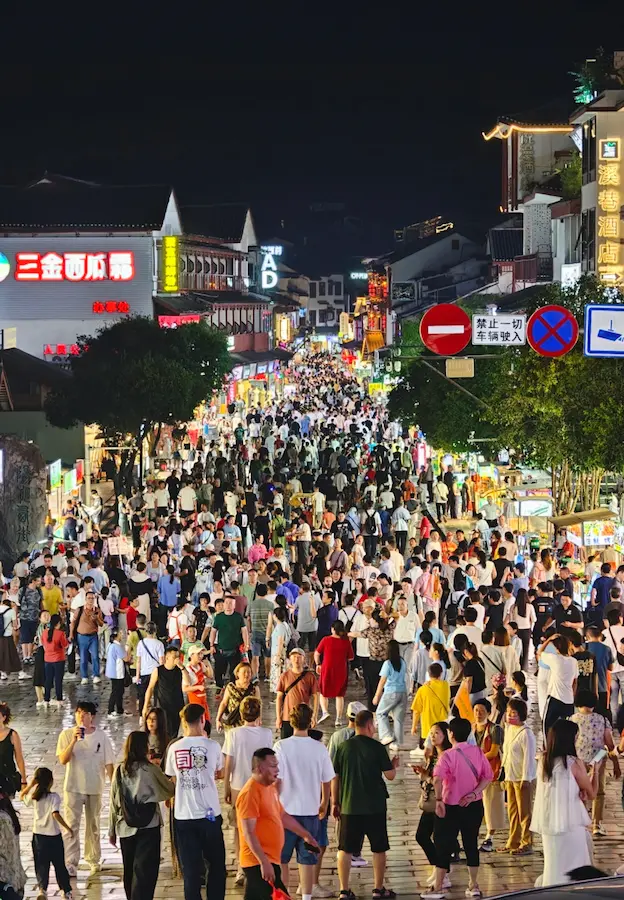 West Street Yangshuo at night with lights and crowds